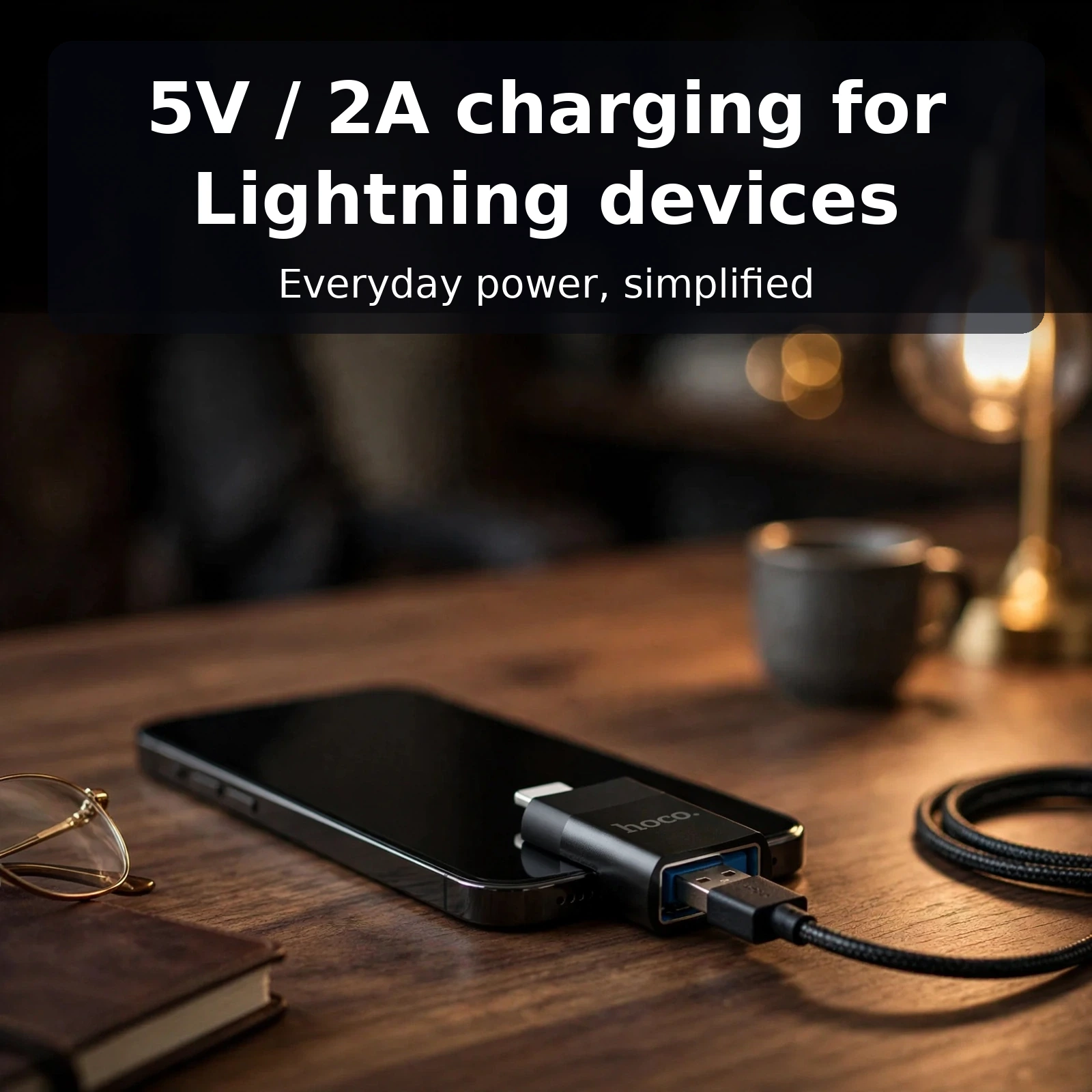Hoco UA17 Lightning to USB adapter plugged into an iPhone with a USB cable connected for 5V 2A charging