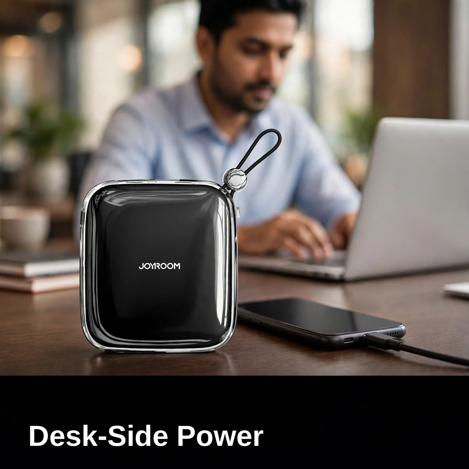 Joyroom JR-L003 power bank on an office desk beside a laptop and phone