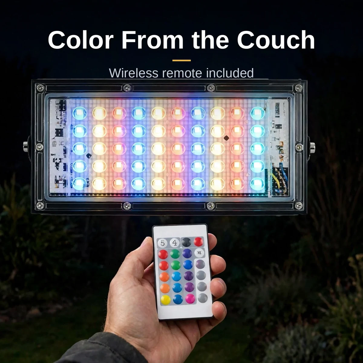 Hand holding the RGB remote toward the glowing LED flood light 50W