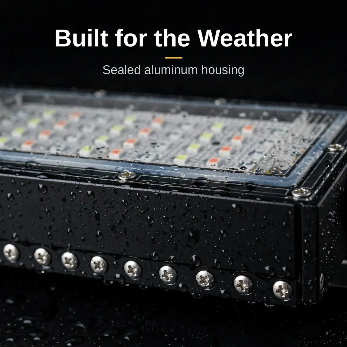 Close-up of the sealed black aluminum housing of the LED flood light 50W with rain droplets