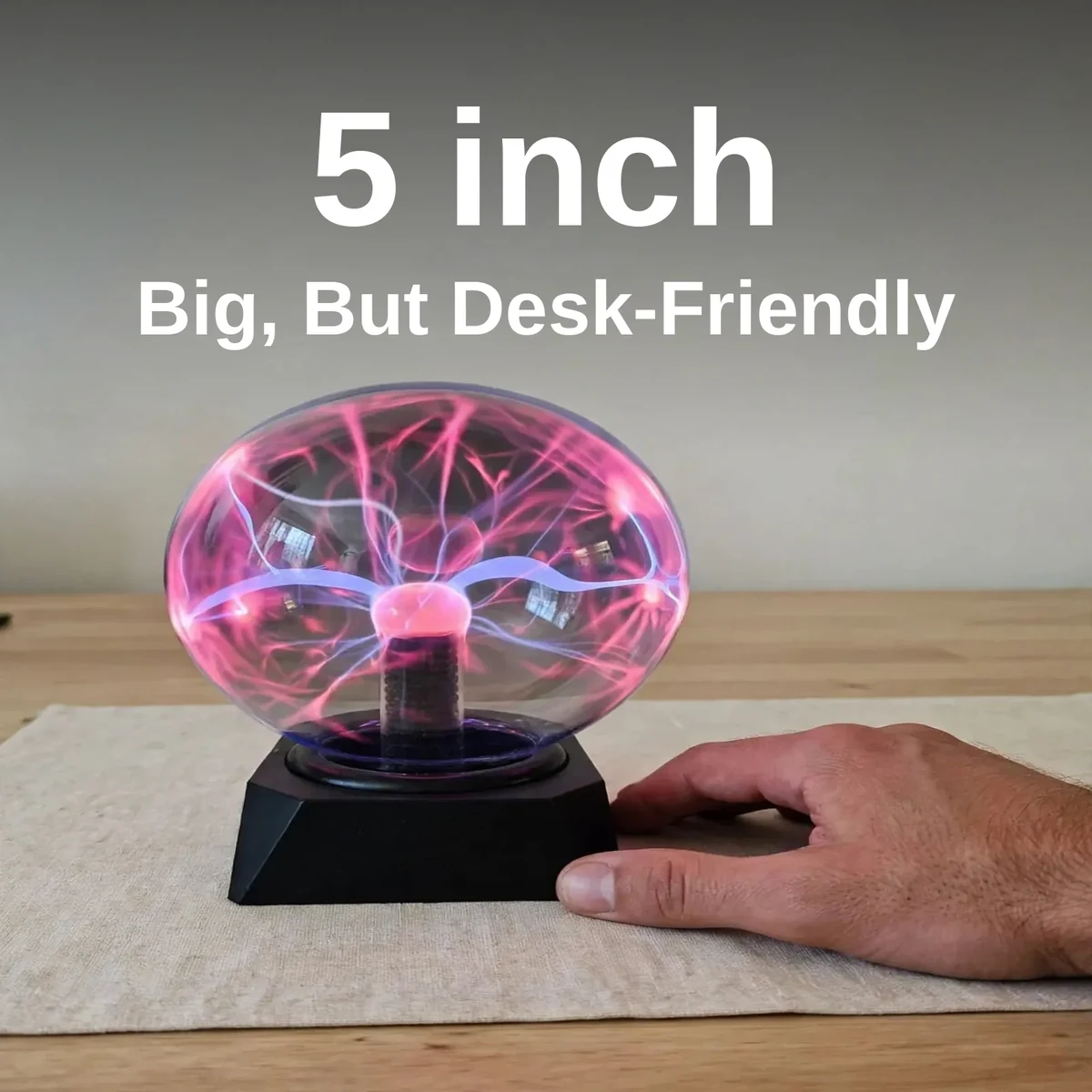 Plasma ball 5 inch beside a hand showing its 5-inch scale
