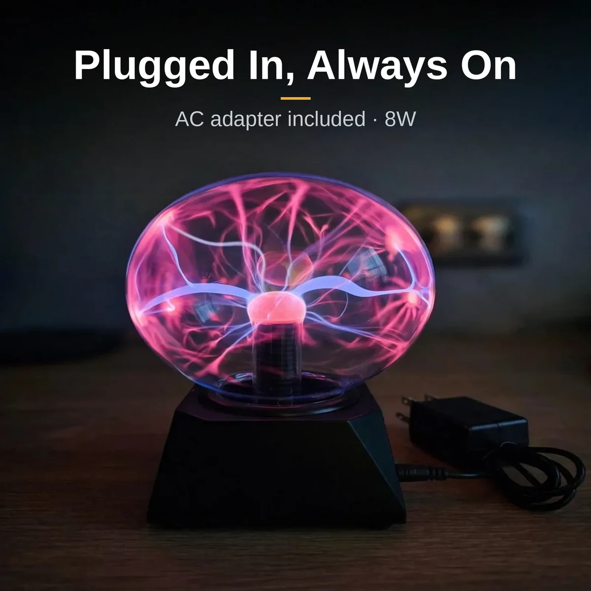 Plasma ball 5 inch with its AC adapter and cable on a desk
