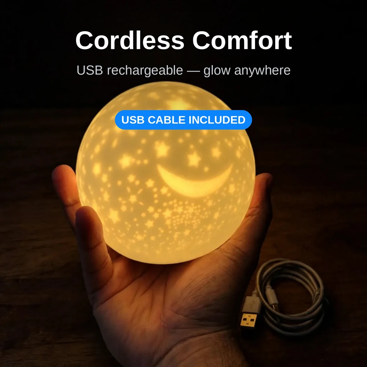 Silicone star night light held cordless in a hand with USB cable beside it