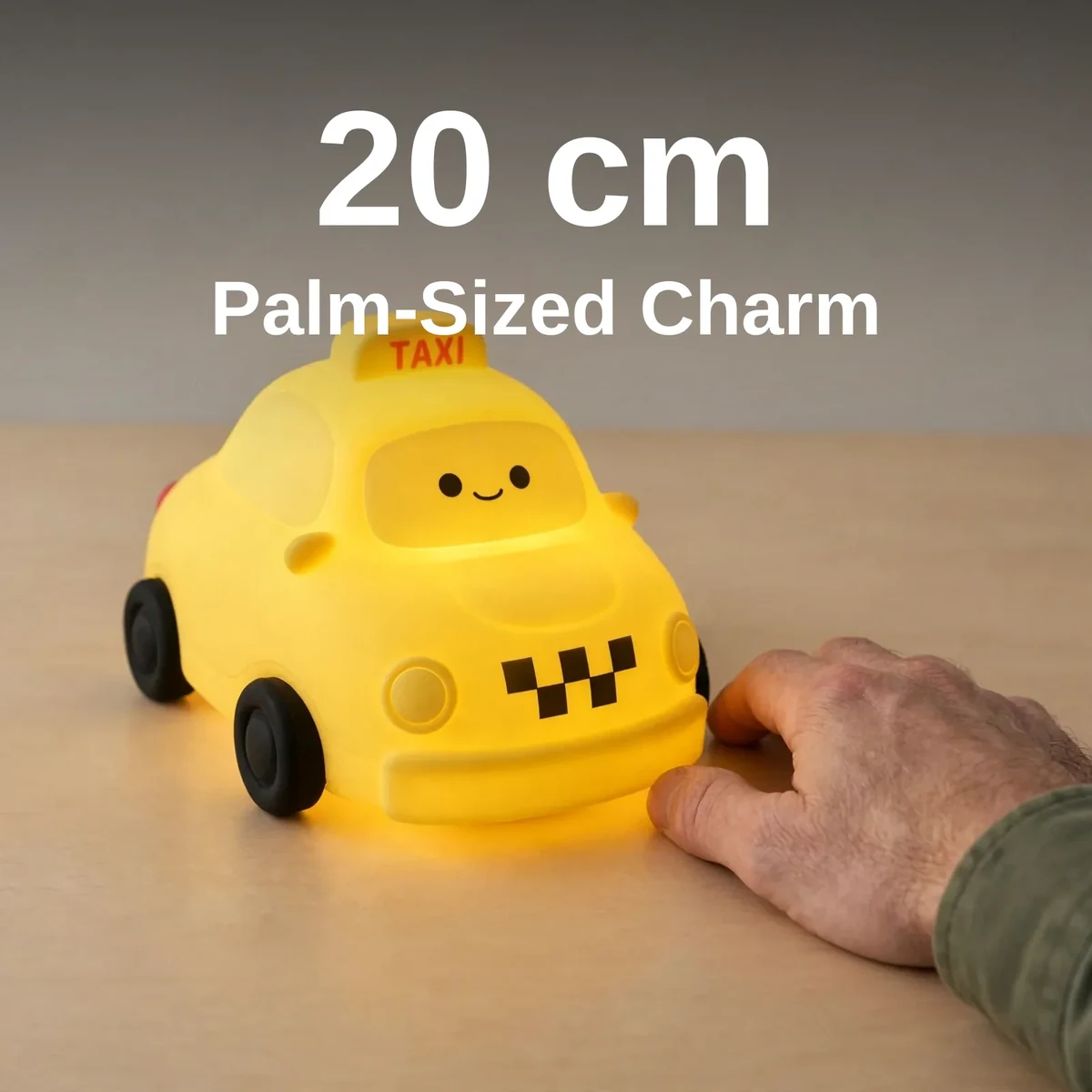 Taxi night lamp beside a hand showing its 20 cm length