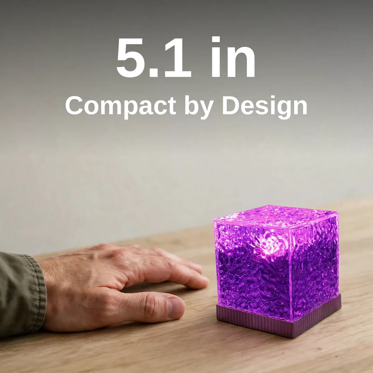 USB water pattern light beside a hand showing its compact 5.1-inch size