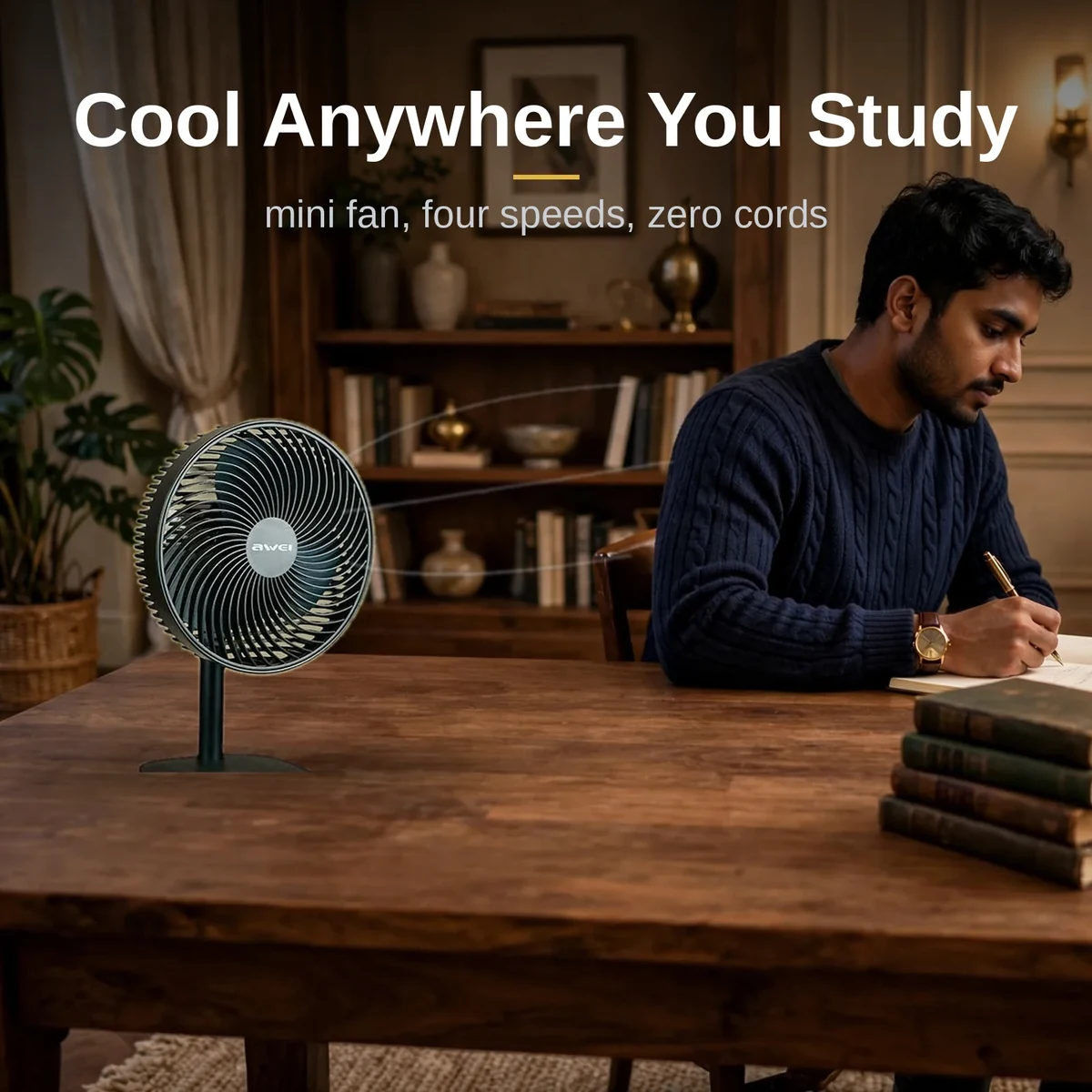 Awei F23 portable USB rechargeable desk fan in black on a study desk