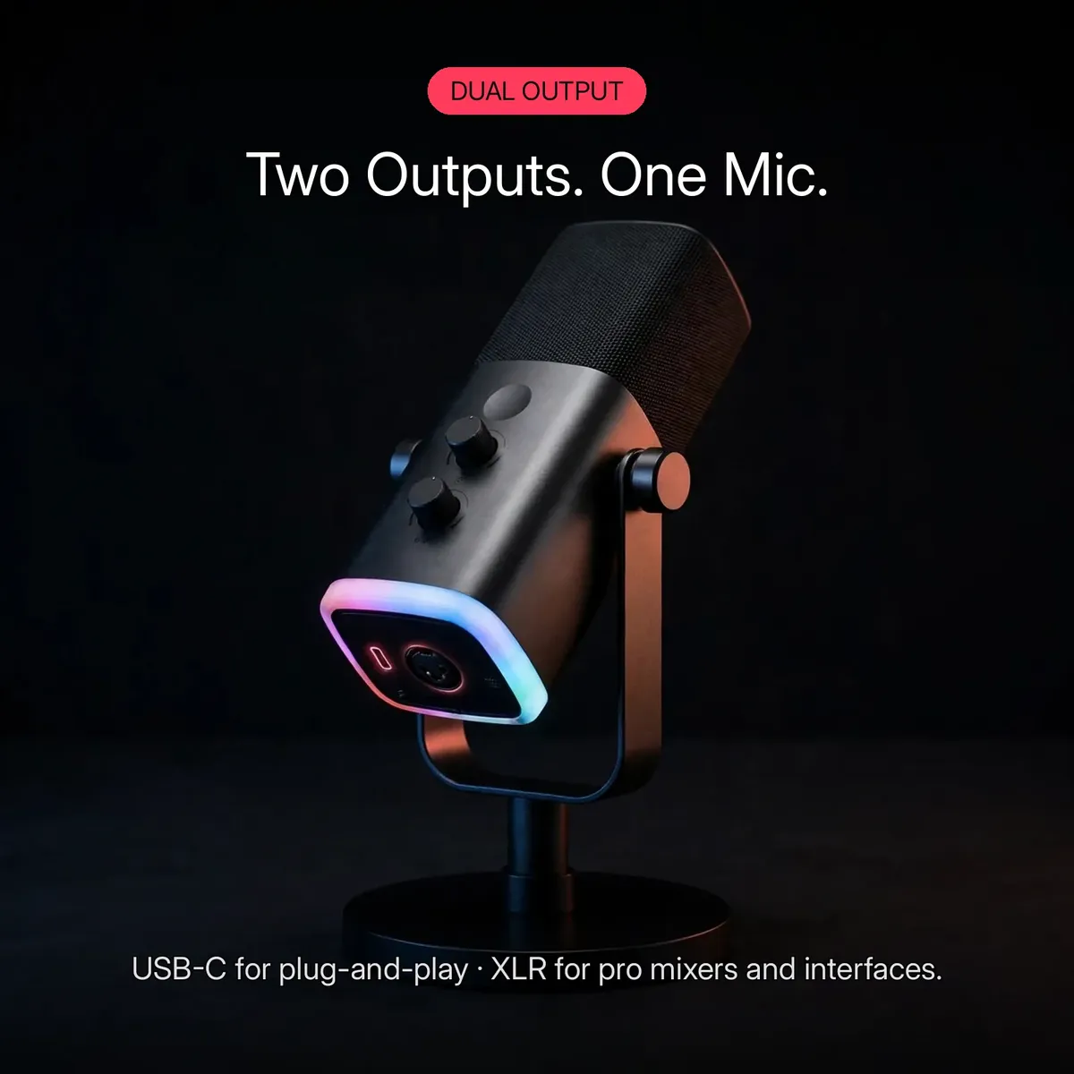 FIFINE AmpliGame AM8 feature card showing the black dynamic microphone on its desktop stand with the glowing USB-C and XLR outputs — Two Outputs. One Mic. USB-C for plug-and-play, XLR for pro mixers and interfaces.