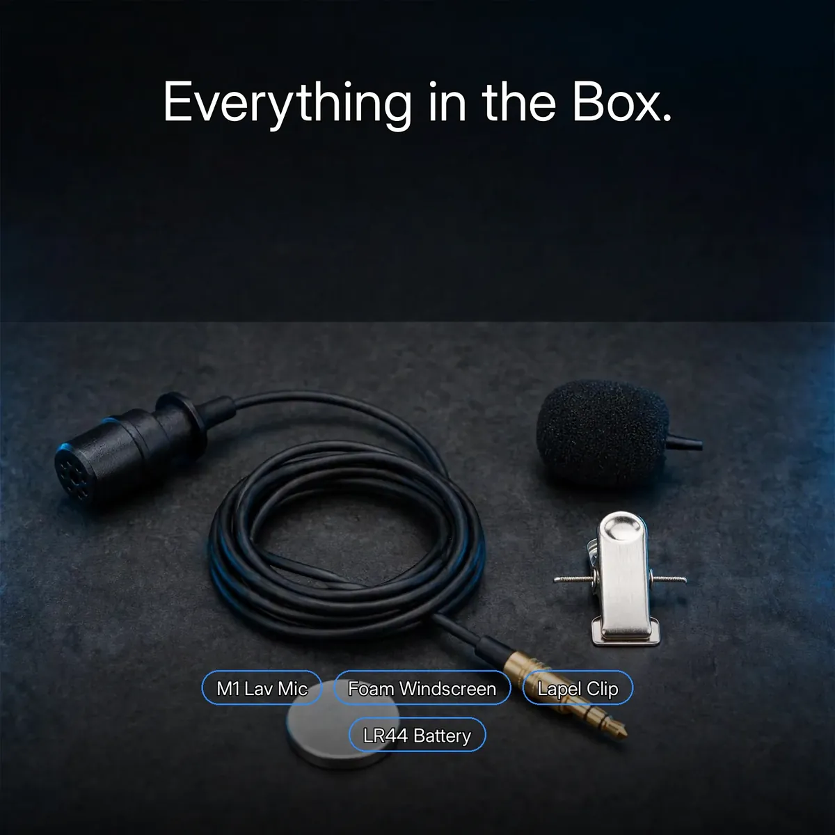 BOYA M1 box-contents flat lay showing the lavalier mic, foam windscreen, lapel clip and LR44 battery