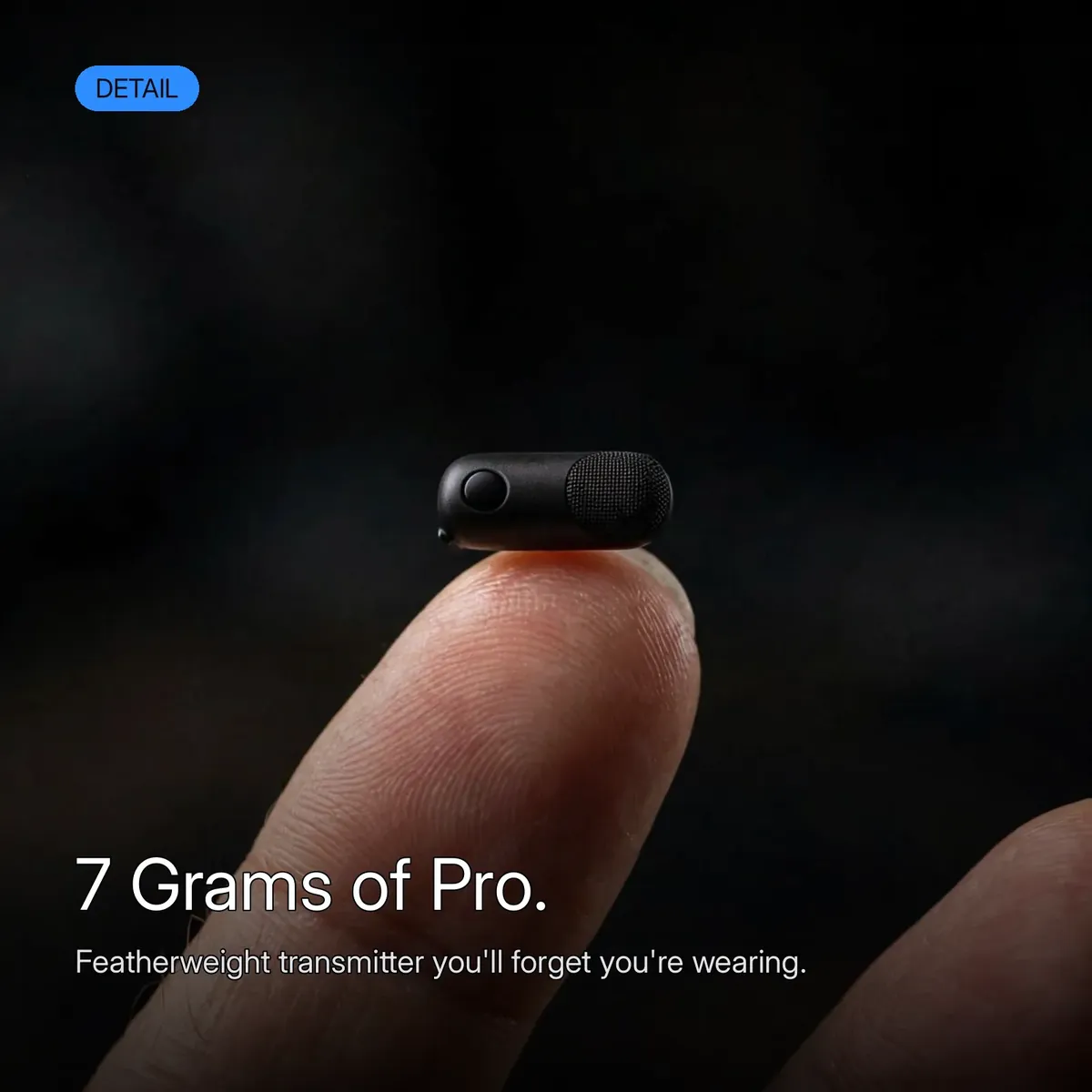 Boya Magic-05 detail macro showing the tiny capsule transmitter balanced on a fingertip — 7 Grams of Pro. Featherweight transmitter you'll forget you're wearing.