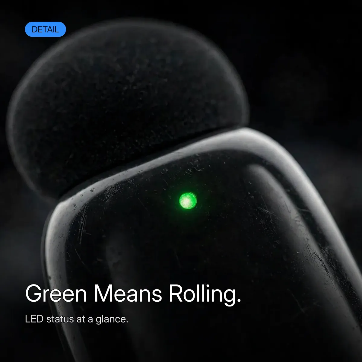 BOYA Mini-16 macro detail of the green LED status dot on the transmitter — Green Means Rolling. LED status at a glance.