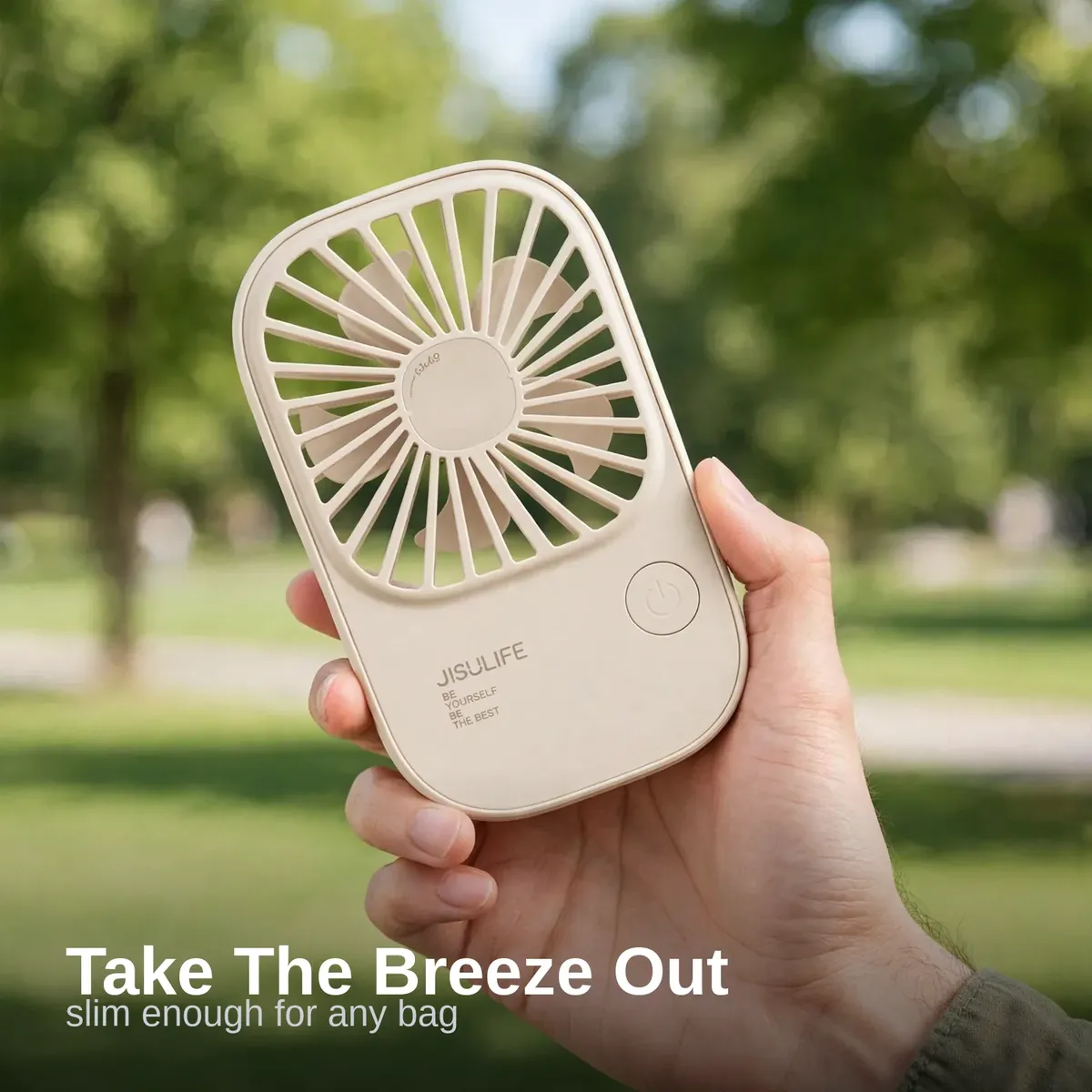 JISULIFE FA49 handheld fan used on an outdoor park walk