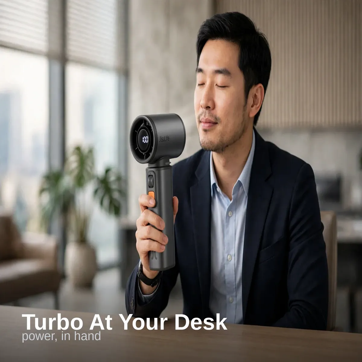 JISULIFE Ultra1 turbo handheld fan at an office desk