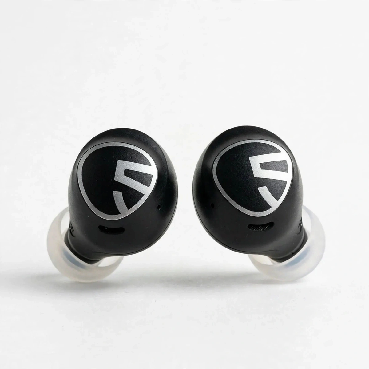 Pair of black SoundPEATS Free2 Classic earbuds with silicone tips standing side by side on a white background