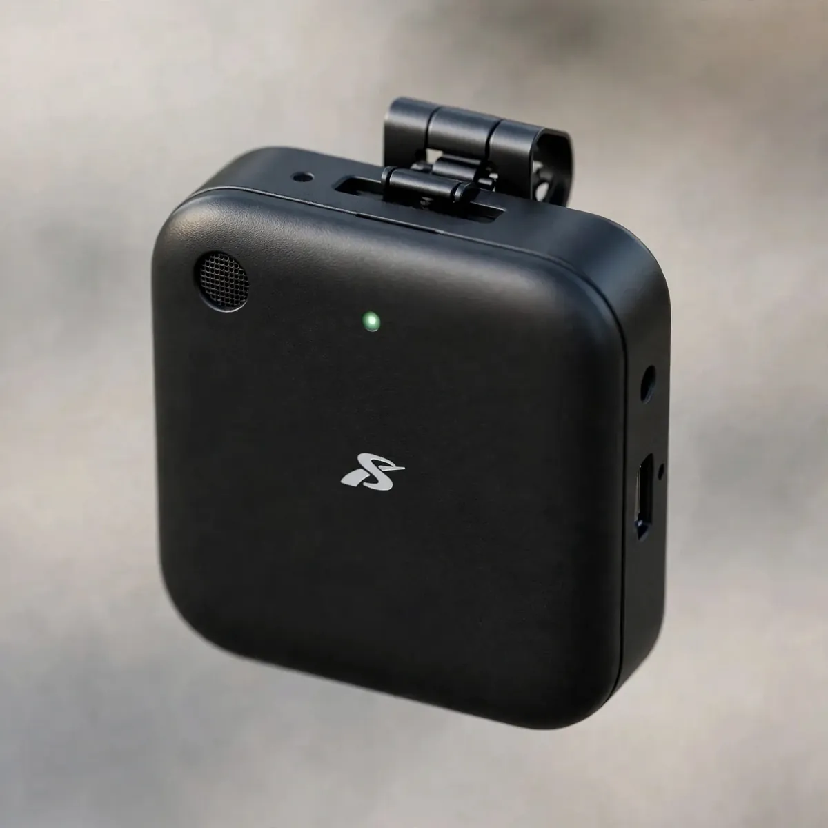 SX63 wireless microphone transmitter macro — rounded-square transmitter with logo, no text.